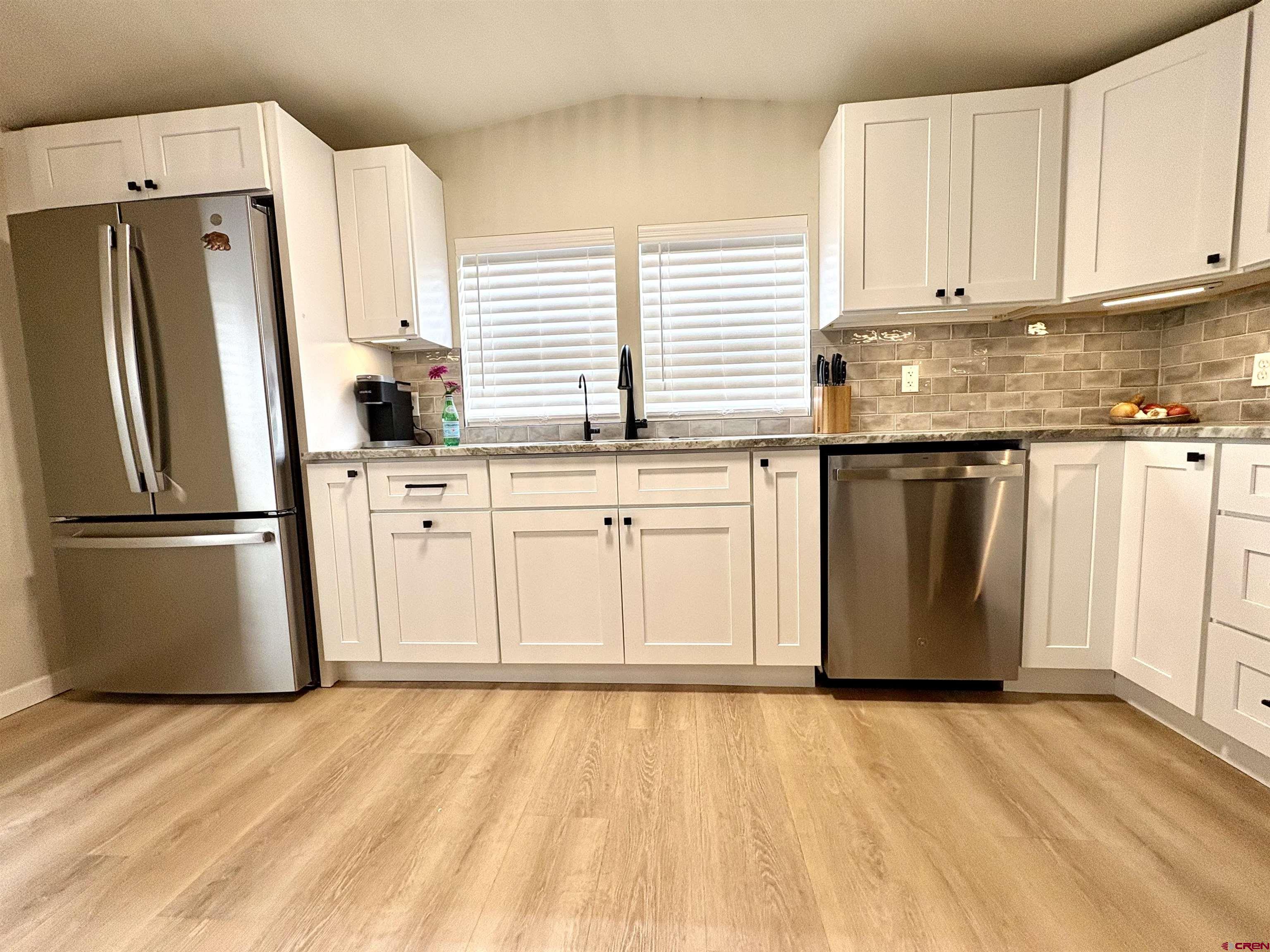 288 Animas View Drive, Unit 11 Durango, CO 81301 - Photo 11 of 23 a kitchen with stainless steel appliances granite countertop a refrigerator sink and cabinets