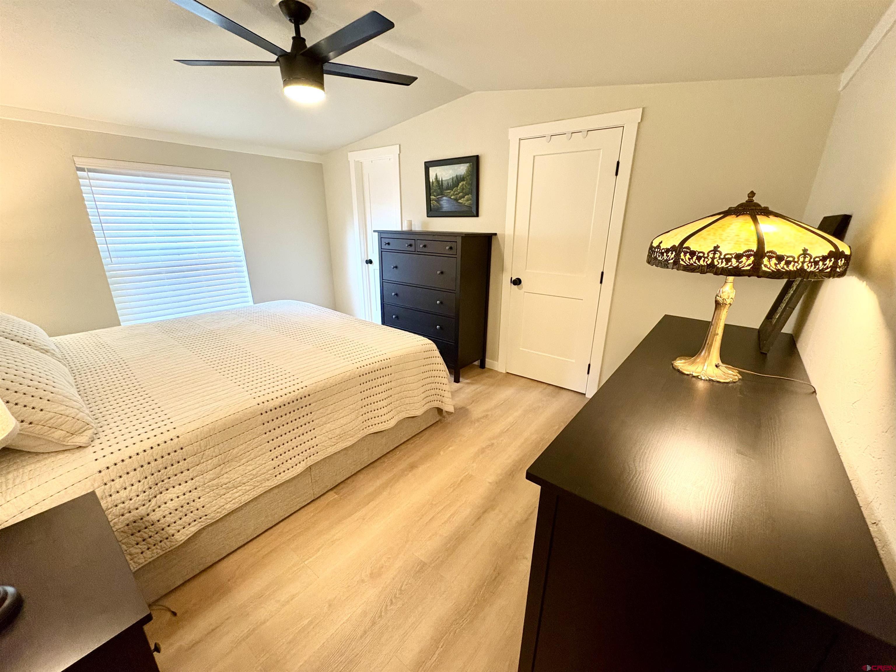288 Animas View Drive, Unit 11 Durango, CO 81301 - Photo 18 of 23 a bedroom with a bed and a chandelier