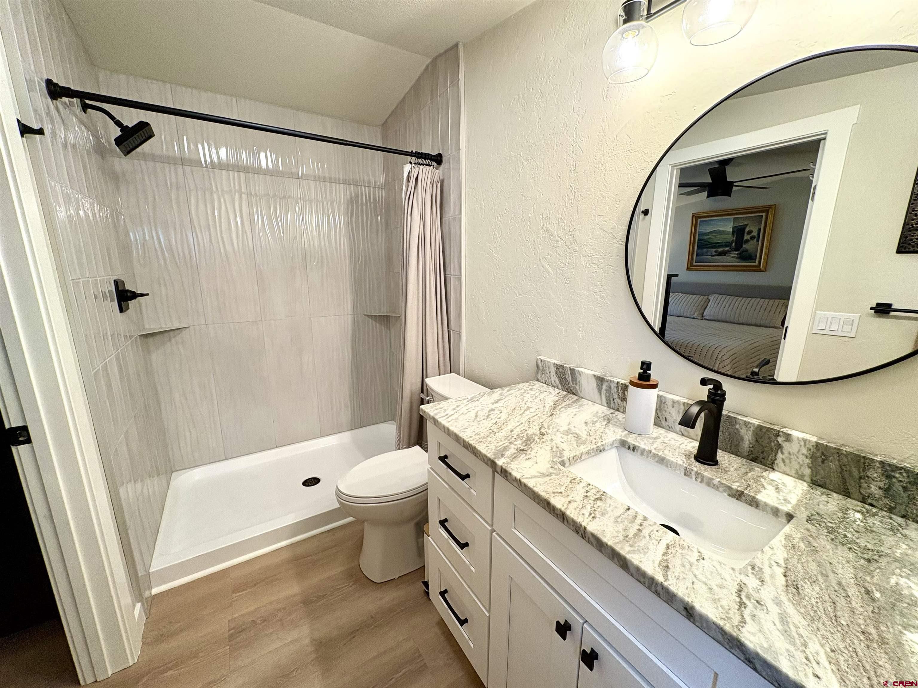 288 Animas View Drive, Unit 11 Durango, CO 81301 - Photo 19 of 23 a bathroom with a granite countertop sink toilet and shower