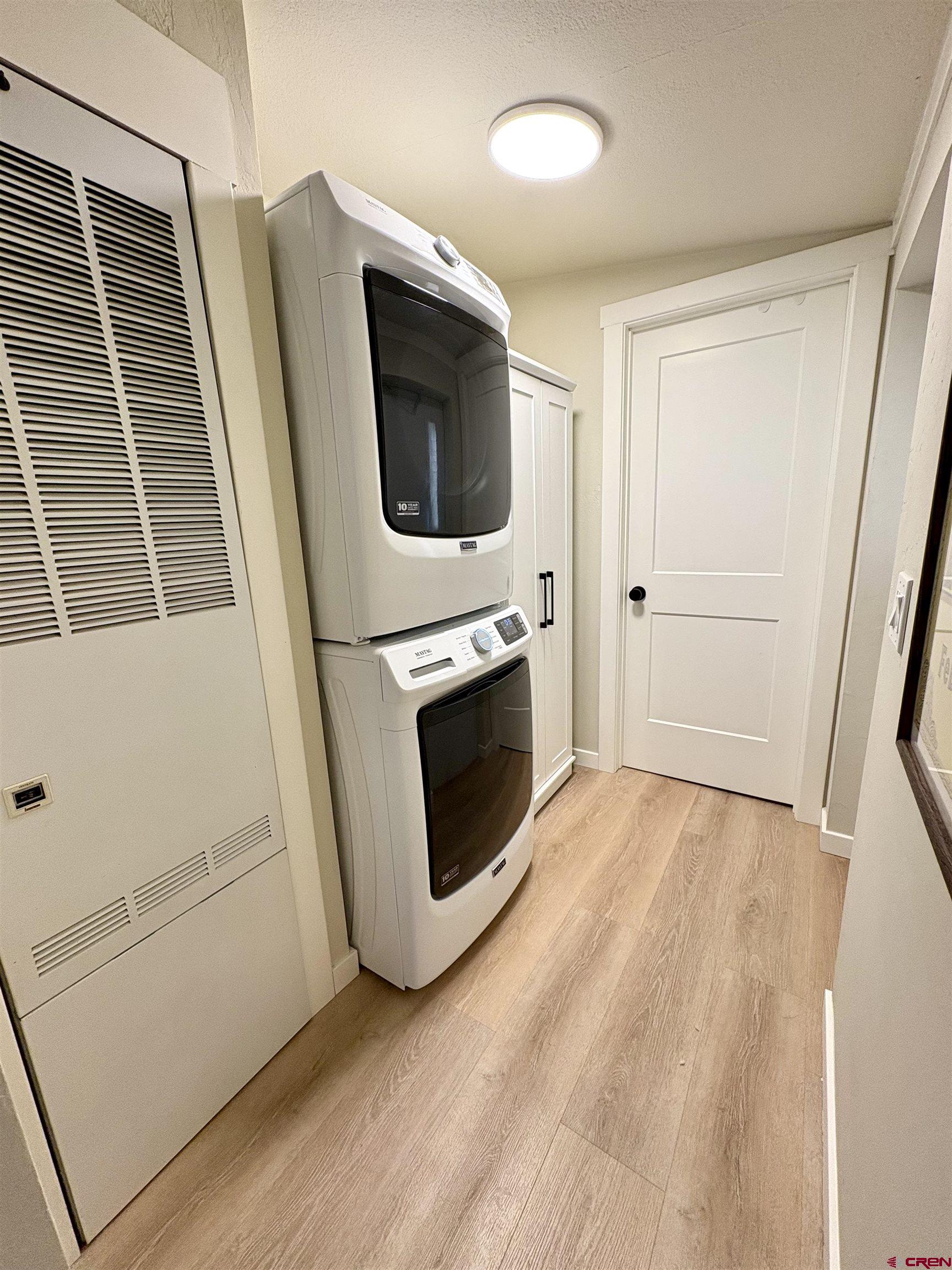 288 Animas View Drive, Unit 11 Durango, CO 81301 - Photo 21 of 23 a view of a livingroom with wooden floor and washing machine
