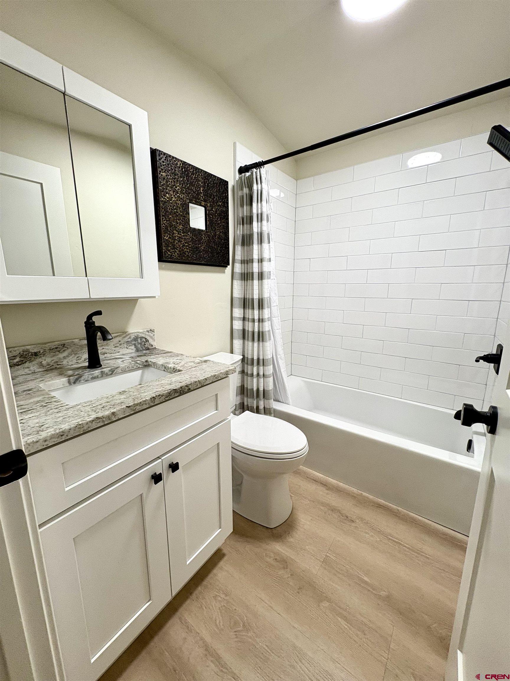 288 Animas View Drive, Unit 11 Durango, CO 81301 - Photo 23 of 23 a bathroom with a granite countertop sink toilet a mirror and shower