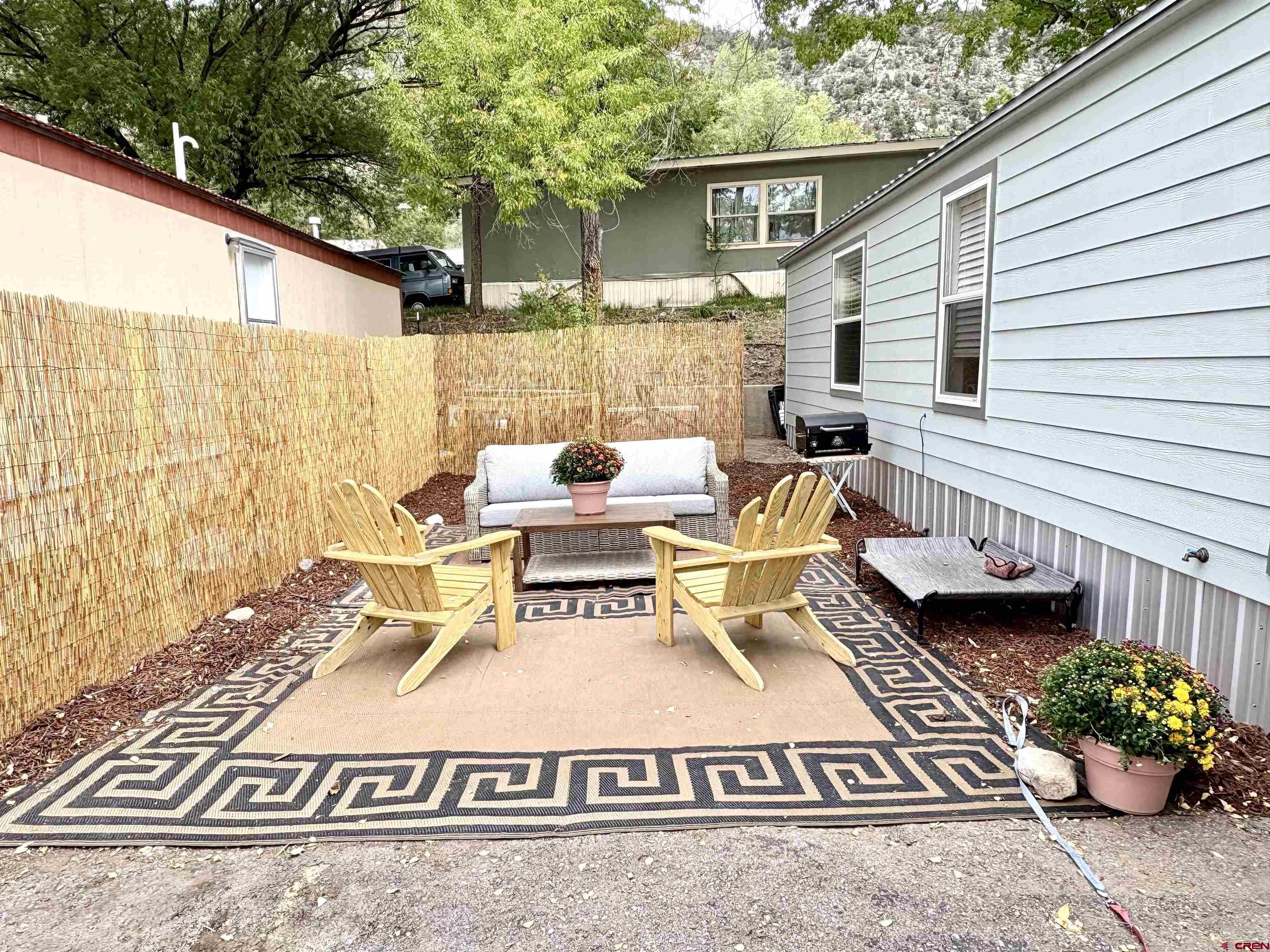 288 Animas View Drive, Unit 11 Durango, CO 81301 - Photo 4 of 23 a view of a patio with couches table and chairs and potted plants
