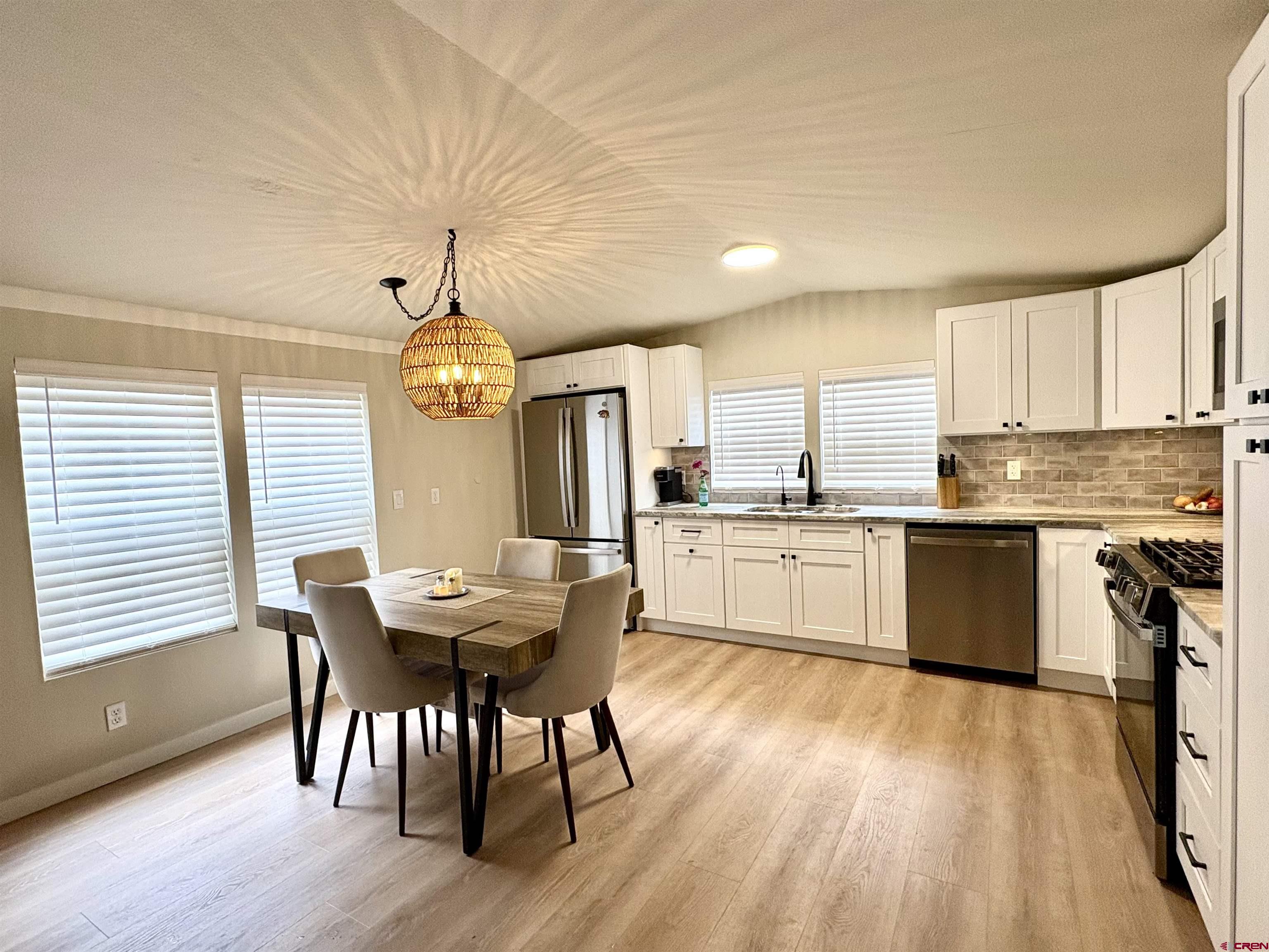 288 Animas View Drive, Unit 11 Durango, CO 81301 - Photo 5 of 23 a view of a dining room with furniture window and wooden floor