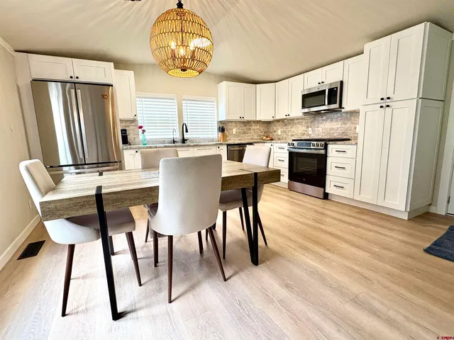a view of kitchen with microwave stove top oven and cabinets