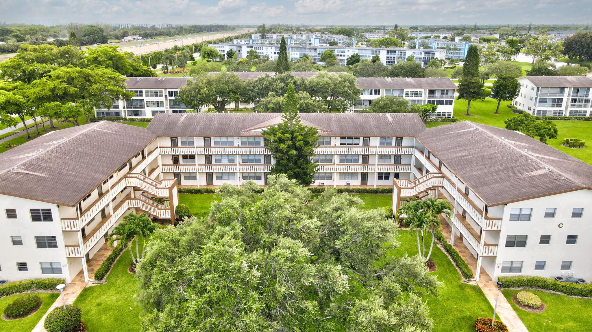 an aerial view of multiple houses with a yard
