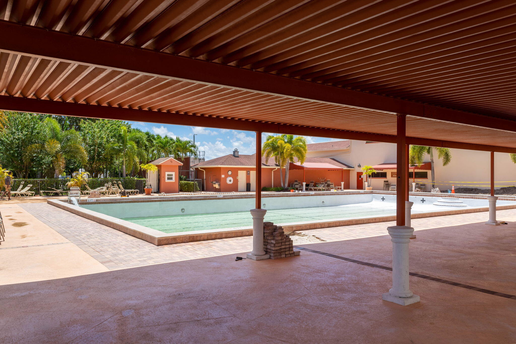 104 Mansfield C, Unit C Boca Raton, FL 33434 - Photo 29 of 40 a view of a swimming pool with a porch