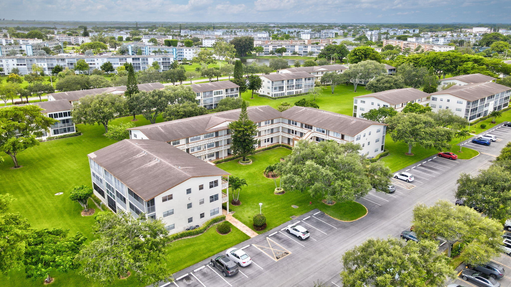 104 Mansfield C, Unit C Boca Raton, FL 33434 - Photo 34 of 40 an aerial view of a house with a garden
