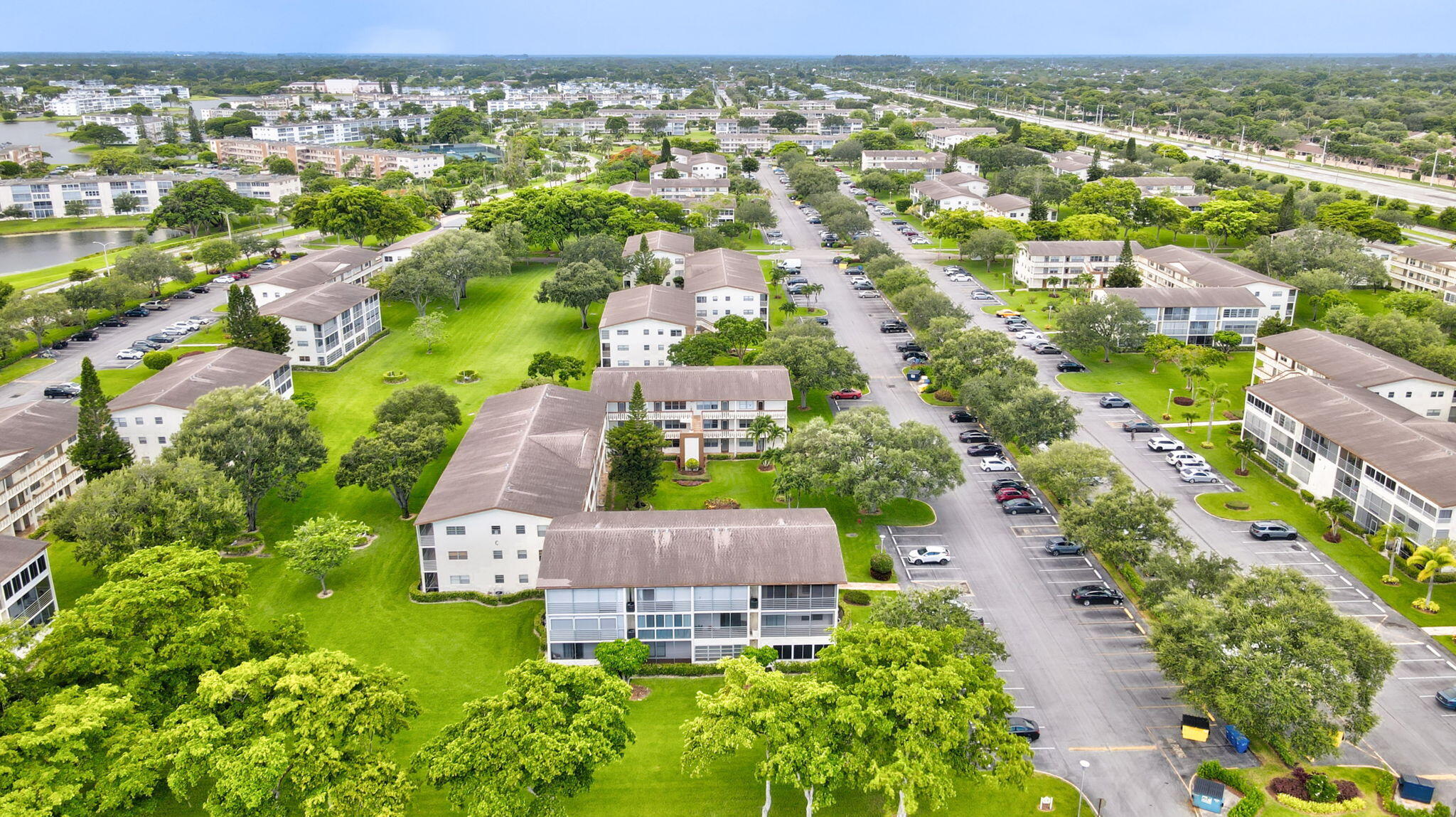 104 Mansfield C, Unit C Boca Raton, FL 33434 - Photo 36 of 40 an aerial view of residential houses with outdoor space