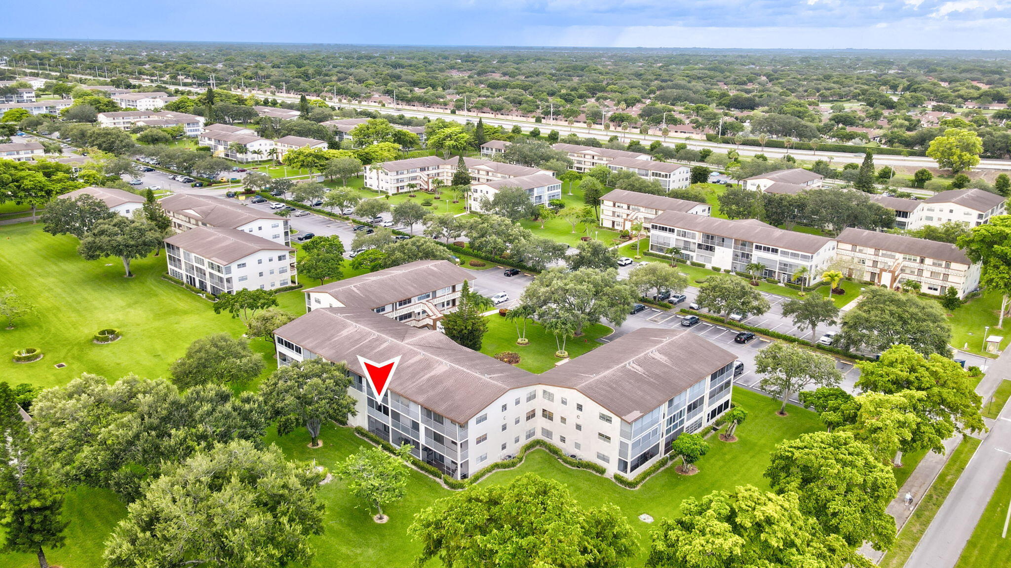 104 Mansfield C, Unit C Boca Raton, FL 33434 - Photo 37 of 40 an aerial view of a house with a garden