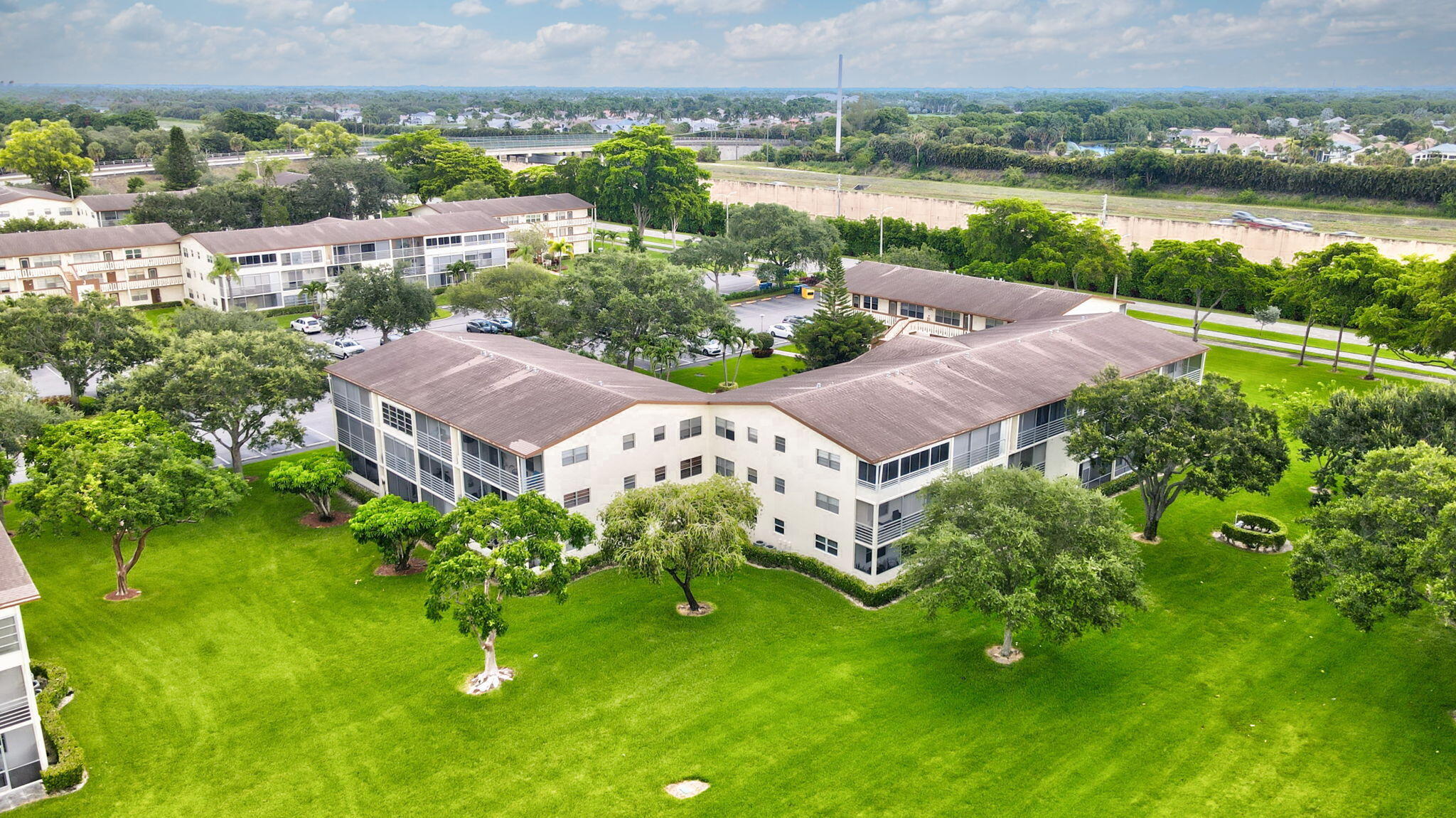 104 Mansfield C, Unit C Boca Raton, FL 33434 - Photo 39 of 40 an aerial view of house with yard and lake view