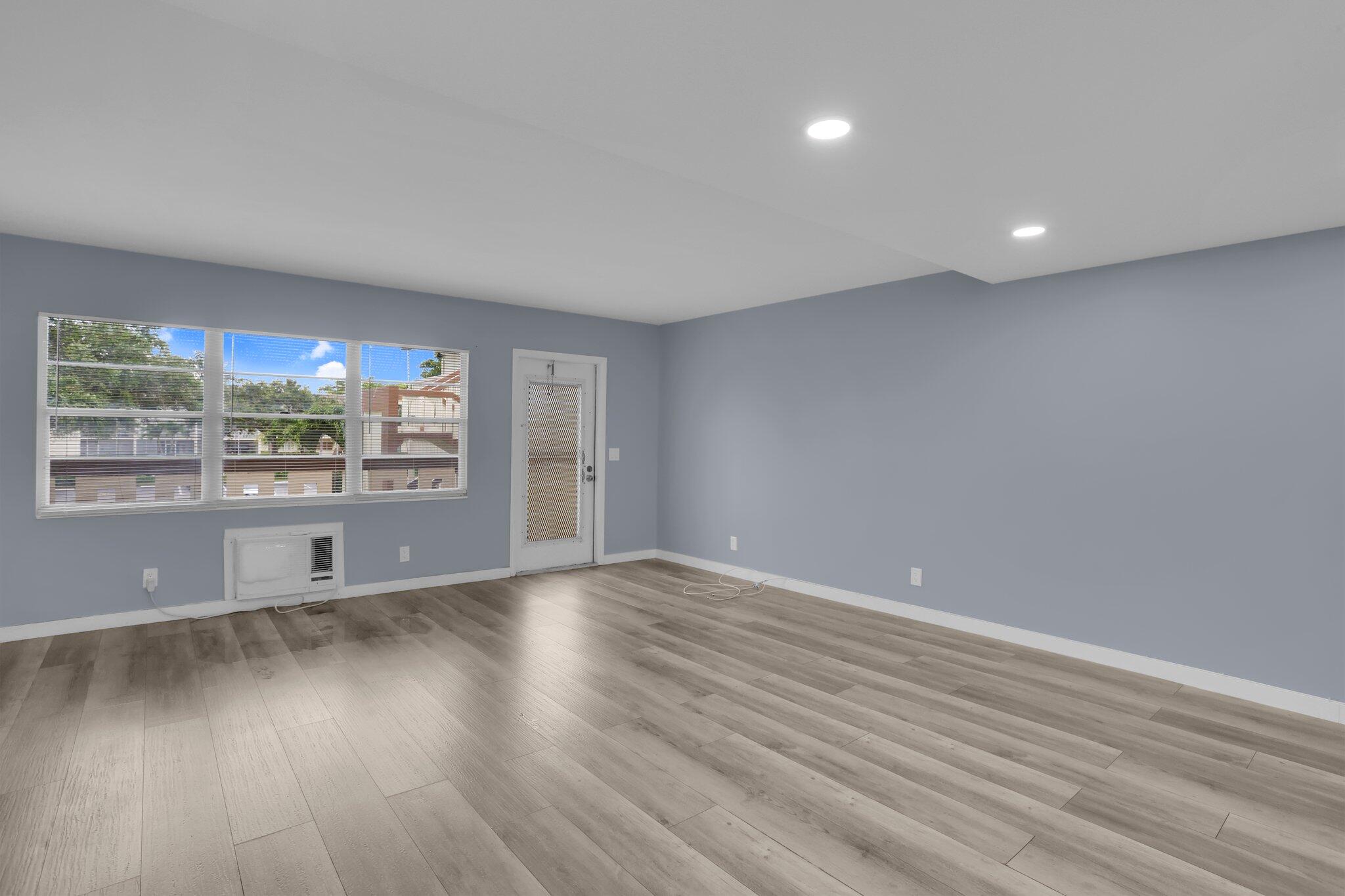104 Mansfield C, Unit C Boca Raton, FL 33434 - Photo 9 of 40 a view of room with window and wooden floor