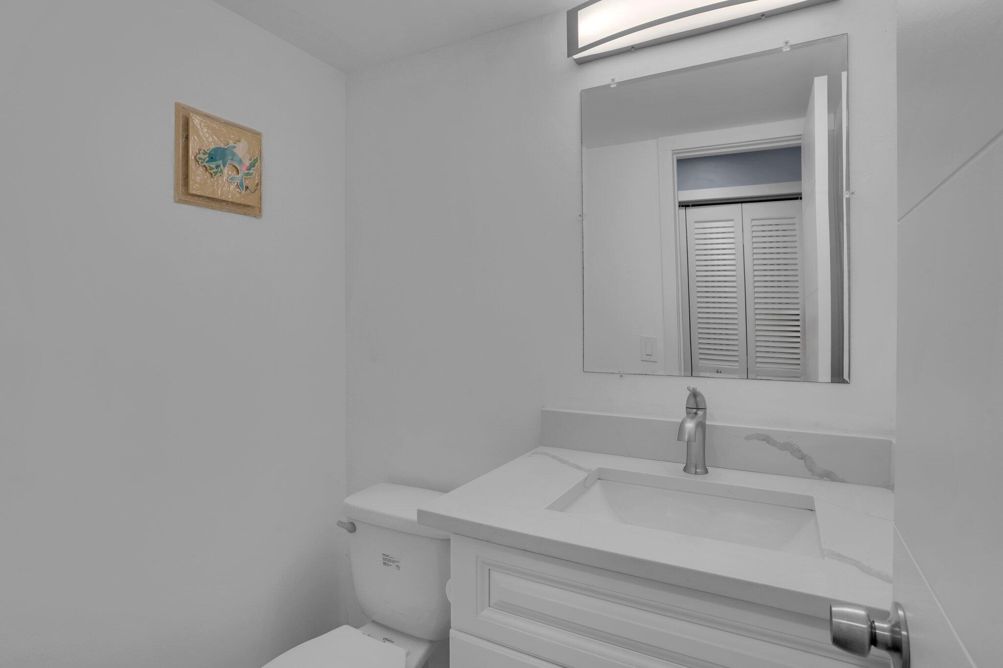 104 Mansfield C, Unit C Boca Raton, FL 33434 - Photo 10 of 40 a bathroom with a sink and a toilet