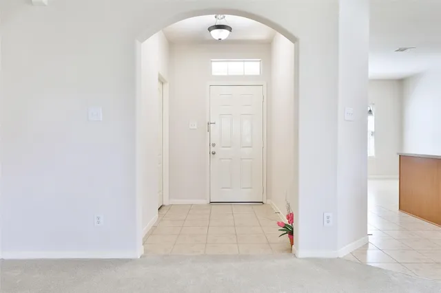 an entryway view with wooden floor and cabinet