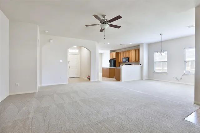 a view of a livingroom with a ceiling fan and window
