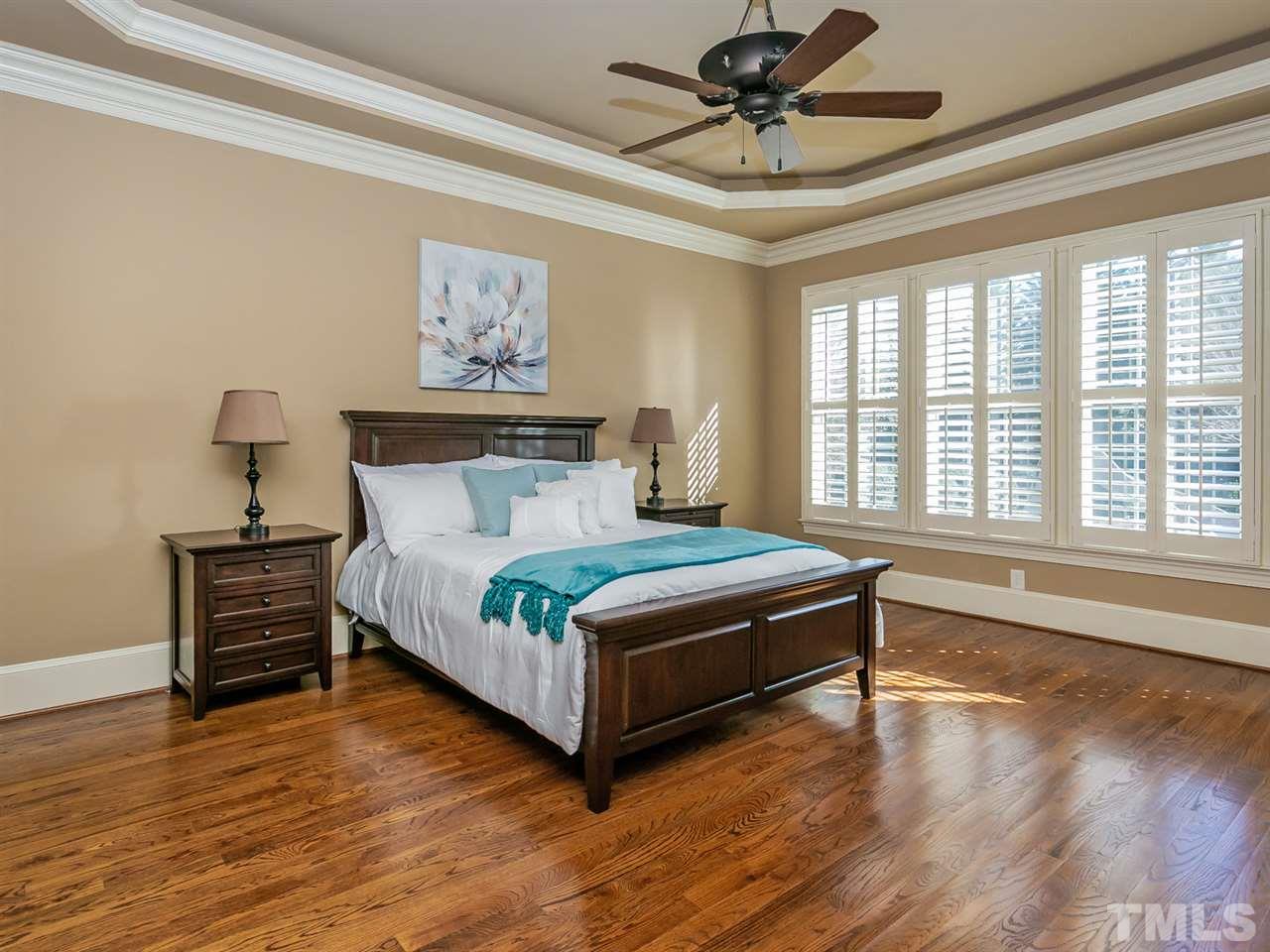 1077 Tacketts Pond Drive Raleigh, NC 27614 - Photo 14 of 30 a bedroom with a bed and wooden floor