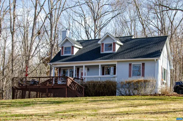 a front view of a house with a yard table and chairs