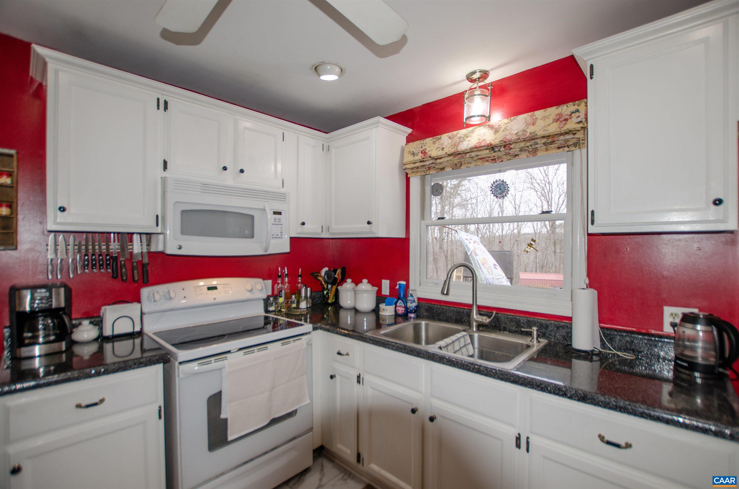 1709 Courthouse Road Palmyra, VA 22963 - Photo 13 of 59 a kitchen with stainless steel appliances cabinets and a window