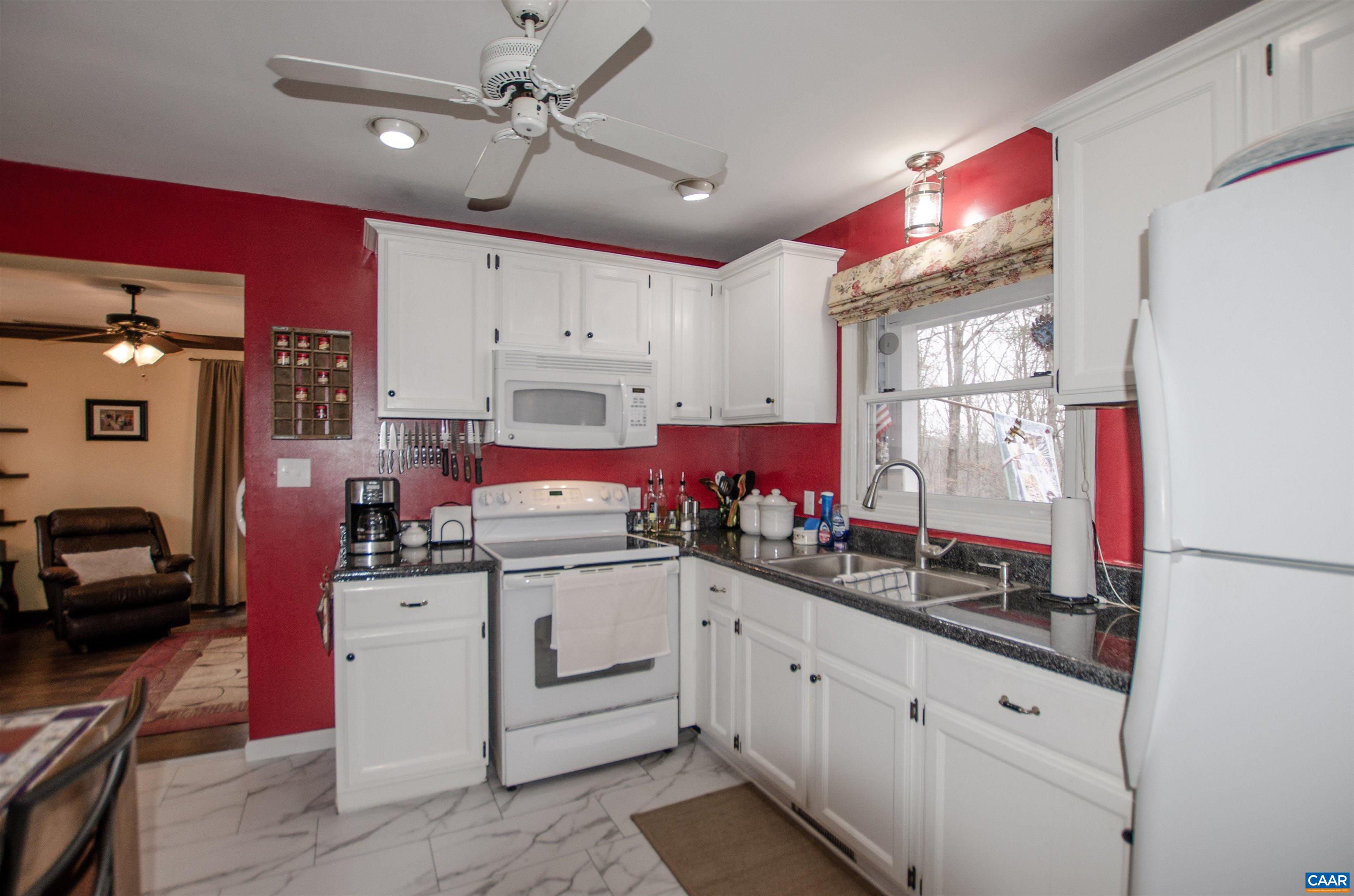 1709 Courthouse Road Palmyra, VA 22963 - Photo 14 of 59 a kitchen that has a lot of cabinets a sink and a stove