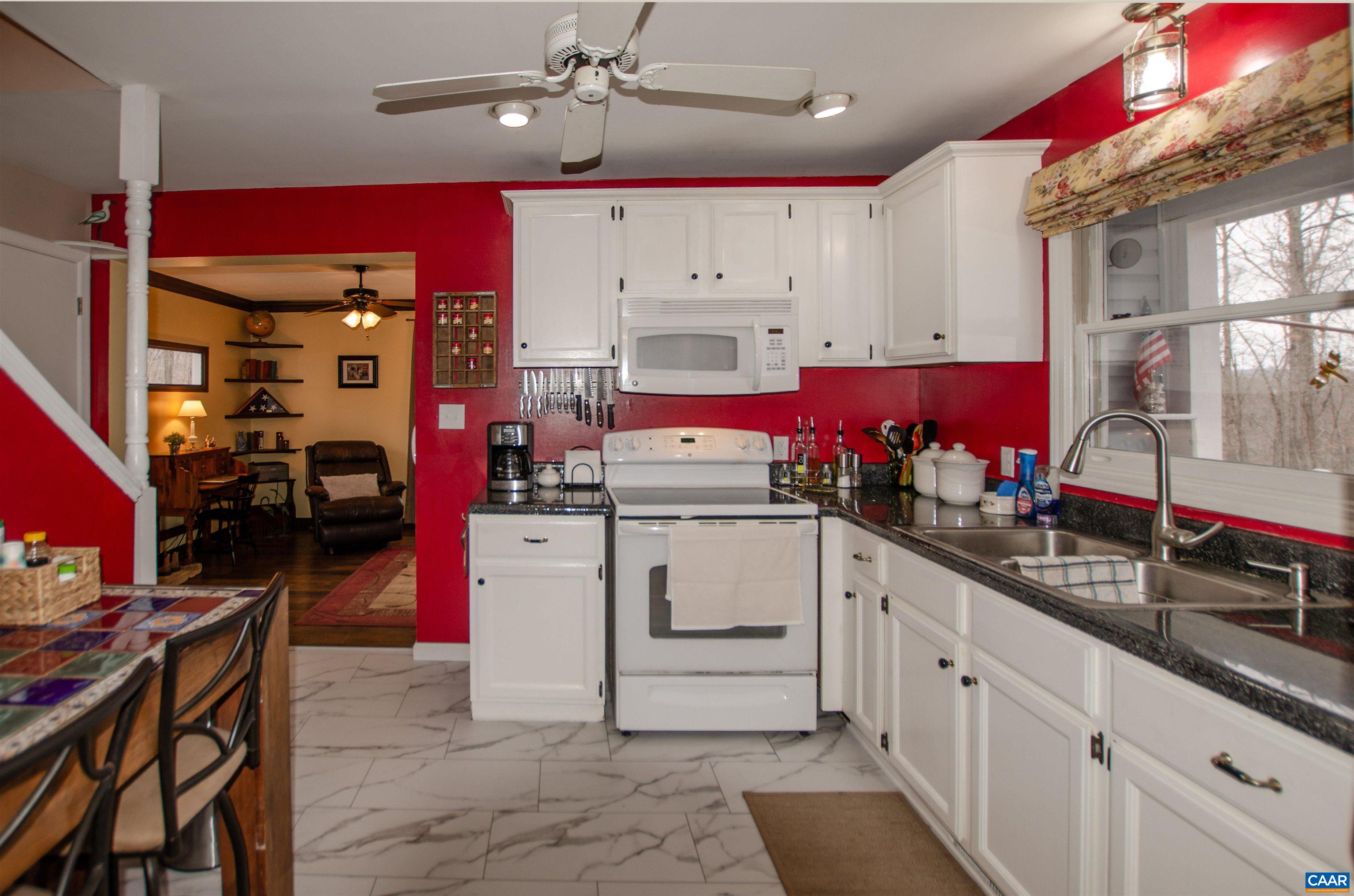 1709 Courthouse Road Palmyra, VA 22963 - Photo 15 of 59 a kitchen that has a lot of cabinets in it and wooden floors