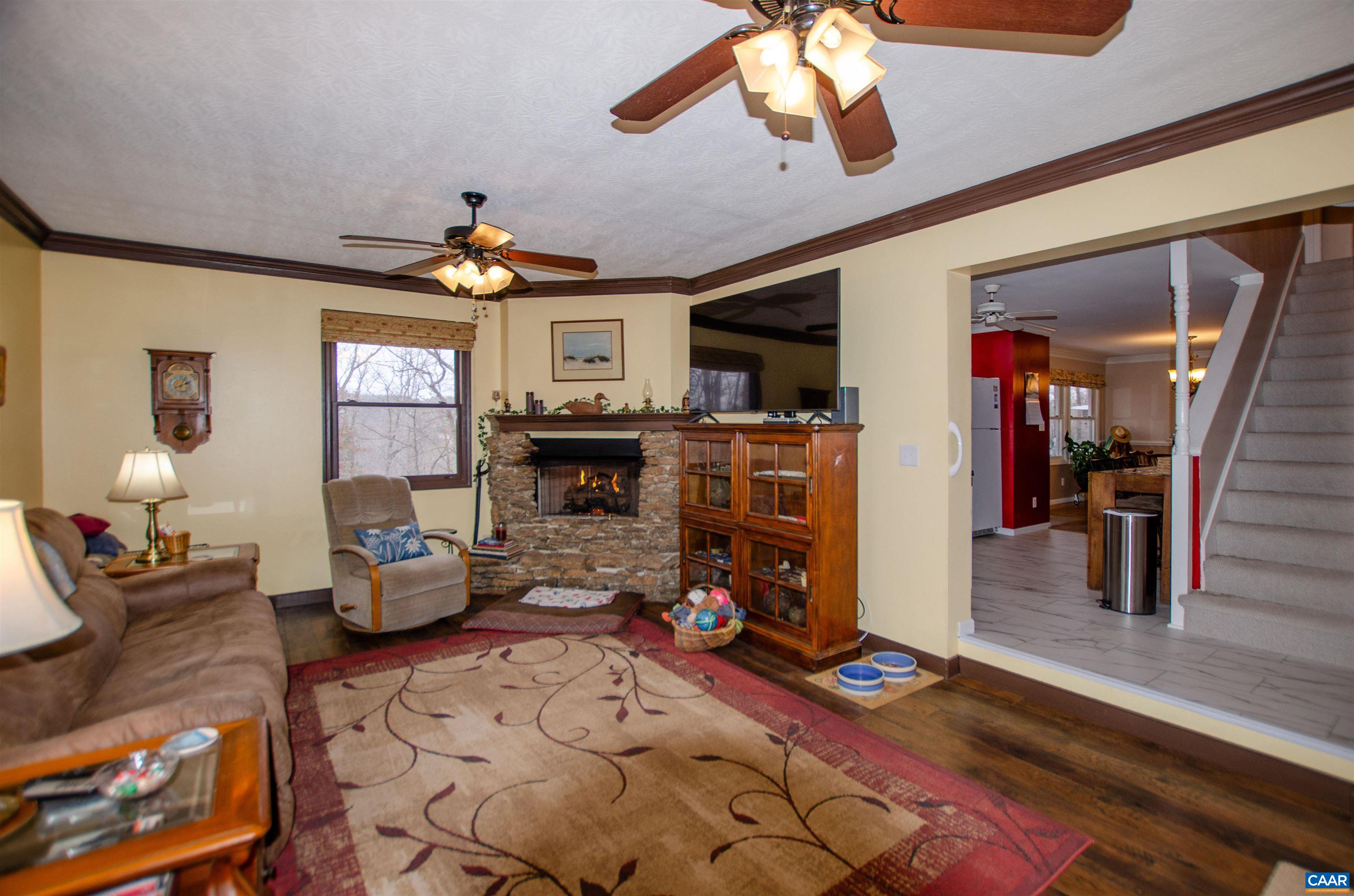 1709 Courthouse Road Palmyra, VA 22963 - Photo 16 of 59 a living room with furniture a rug and a chandelier