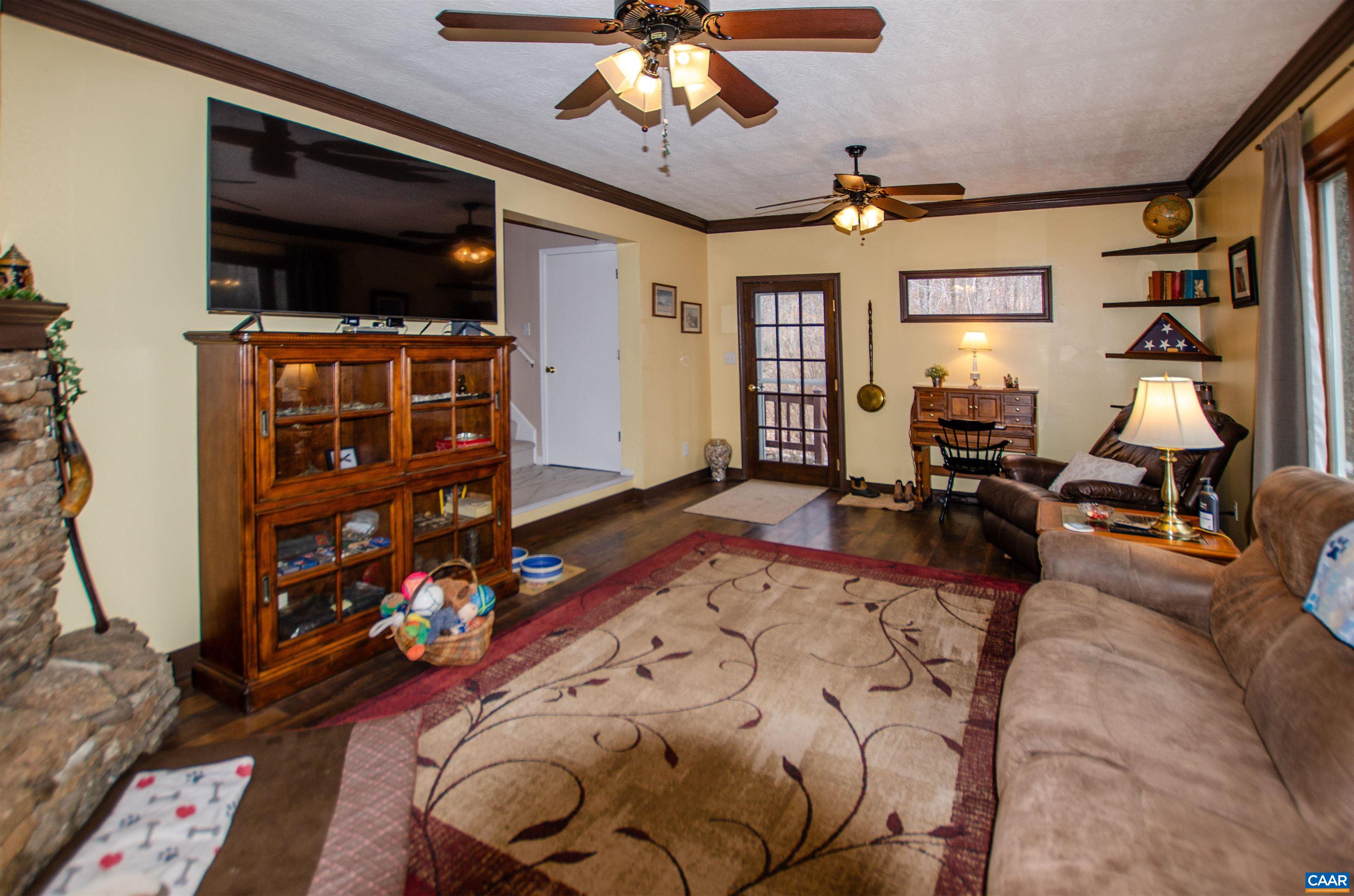 1709 Courthouse Road Palmyra, VA 22963 - Photo 18 of 59 a living room with furniture a flat screen tv and a fireplace