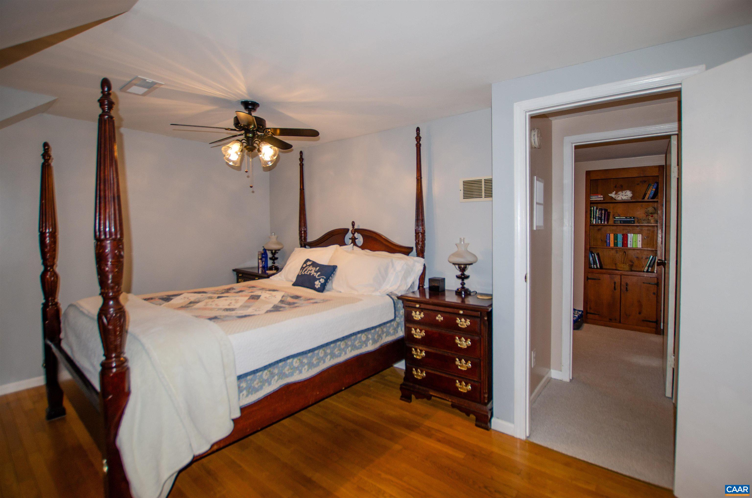 1709 Courthouse Road Palmyra, VA 22963 - Photo 29 of 59 a bedroom with a bed and a chandelier