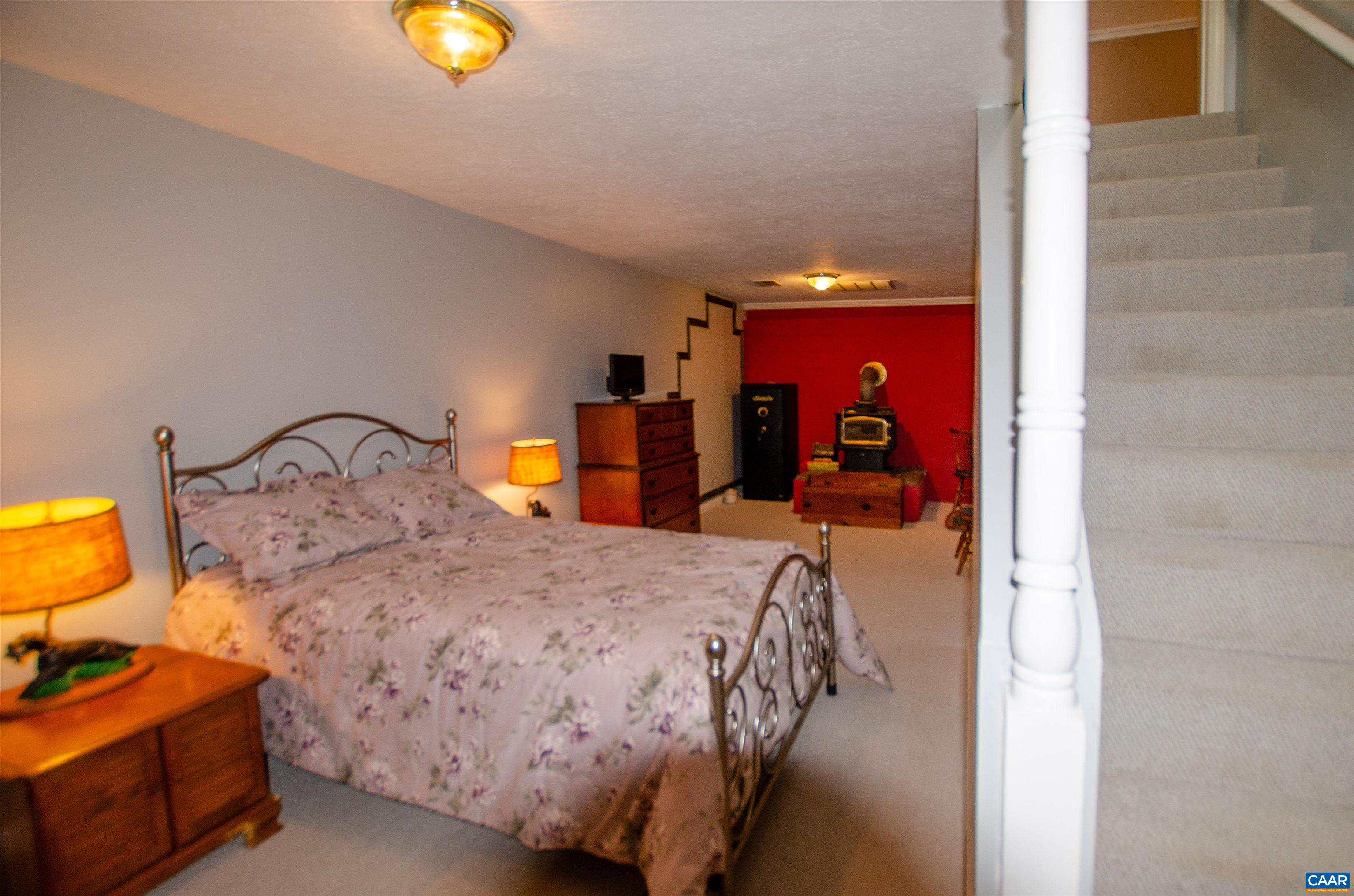 1709 Courthouse Road Palmyra, VA 22963 - Photo 33 of 59 a bedroom with a bed and a lamp