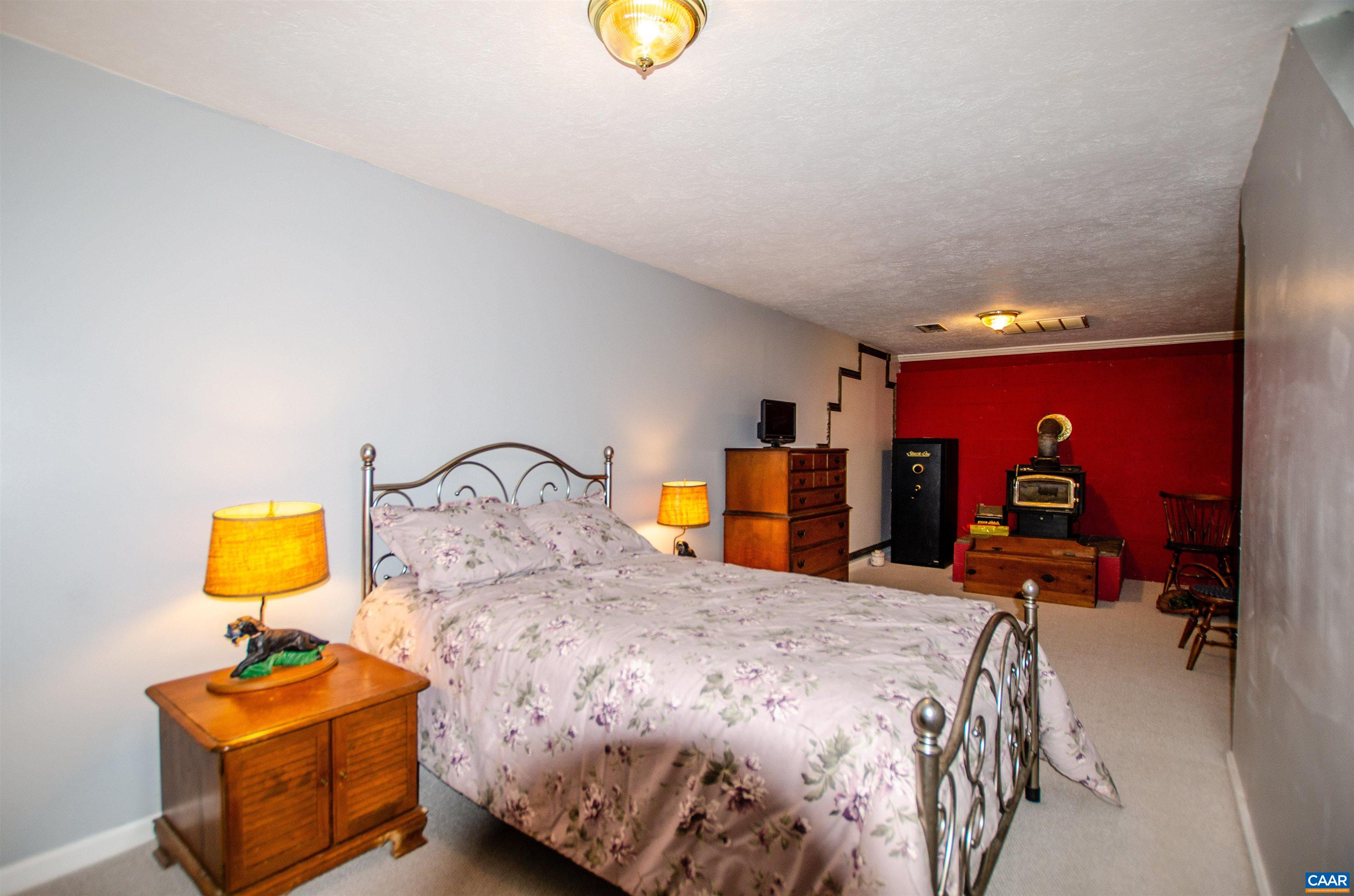 1709 Courthouse Road Palmyra, VA 22963 - Photo 34 of 59 a bedroom with a bed and a lamp on table