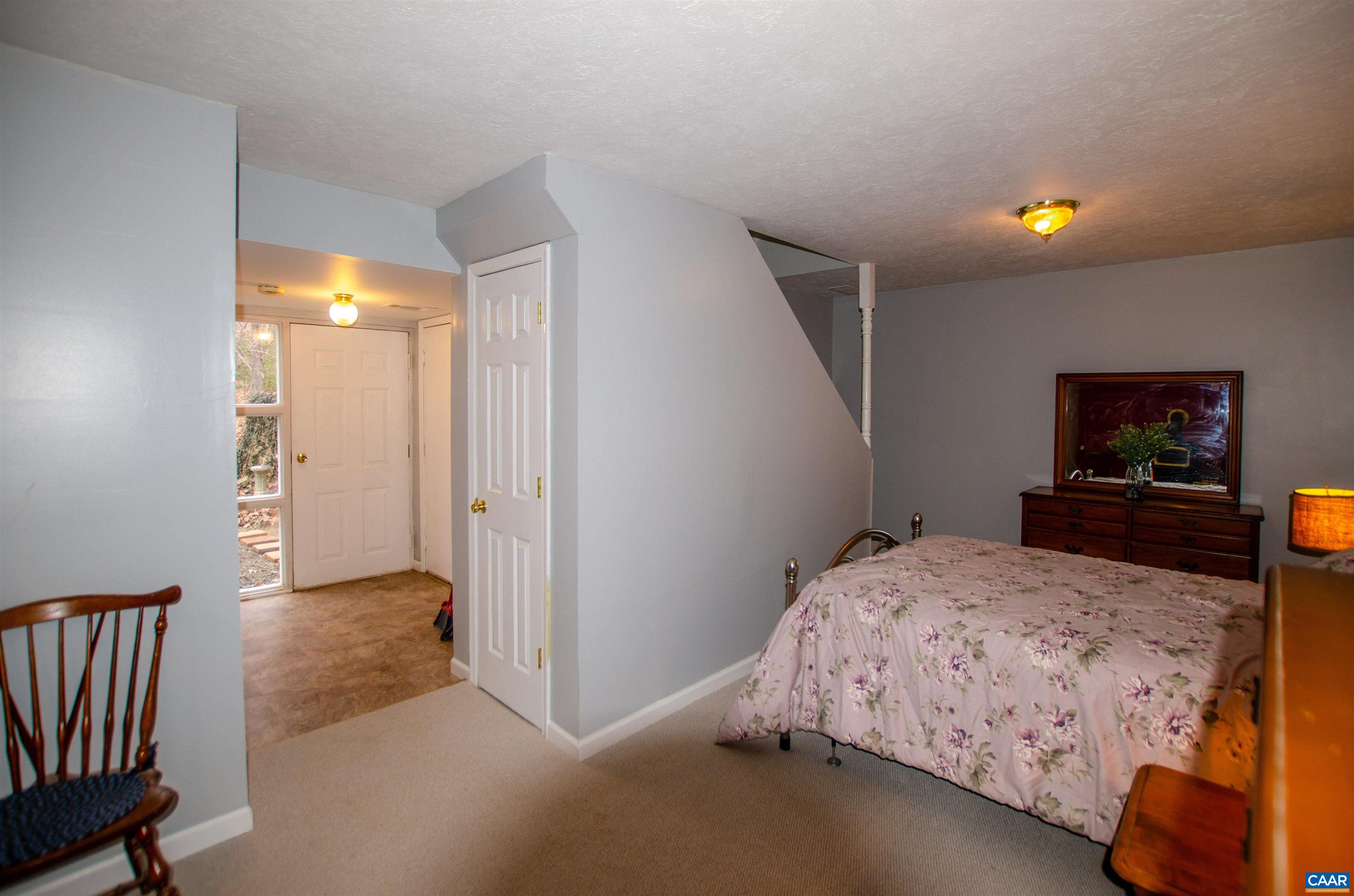 1709 Courthouse Road Palmyra, VA 22963 - Photo 37 of 59 a bedroom with a bed and a flat tv screen on dresser
