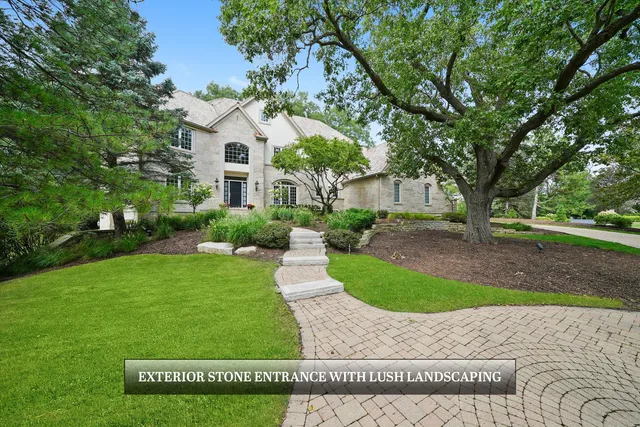 a dining room with wooden floor a chandelier a wooden table and chairs