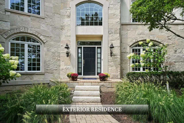 a kitchen with stainless steel appliances granite countertop a stove a refrigerator a dining table and chairs with wooden floor