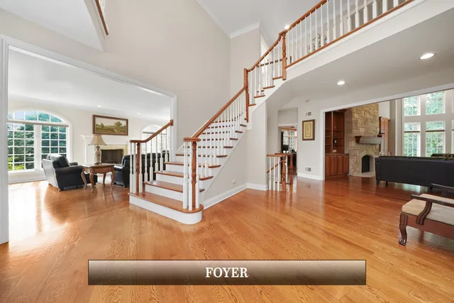 a kitchen with stainless steel appliances granite countertop a stove top oven a sink a dining table and chairs with wooden floor