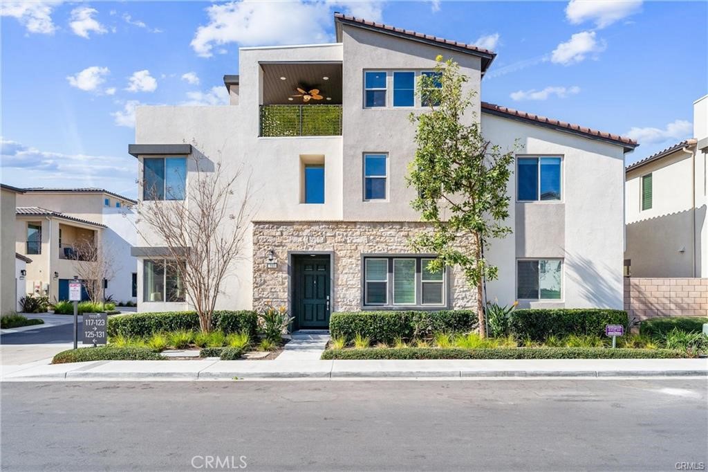a front view of a house with a garden and plants