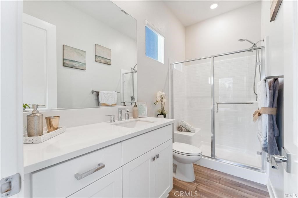 117 Denali Lake Forest, CA 92630 - Photo 12 of 40 a bathroom with a granite countertop sink toilet a mirror a vanity and shower