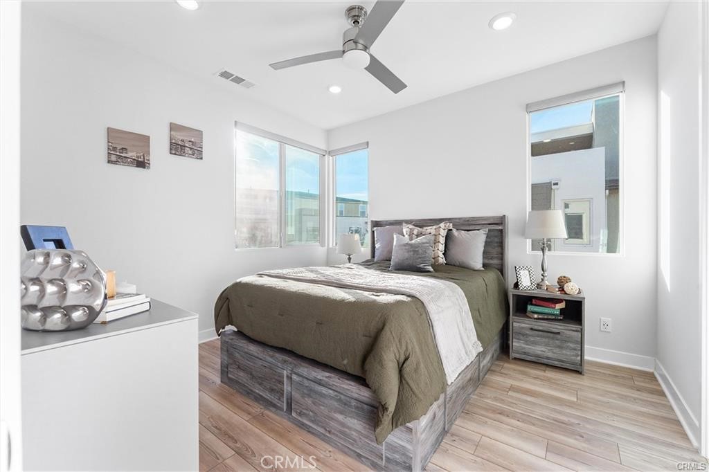 117 Denali Lake Forest, CA 92630 - Photo 21 of 40 a bedroom with a bed and wooden floor