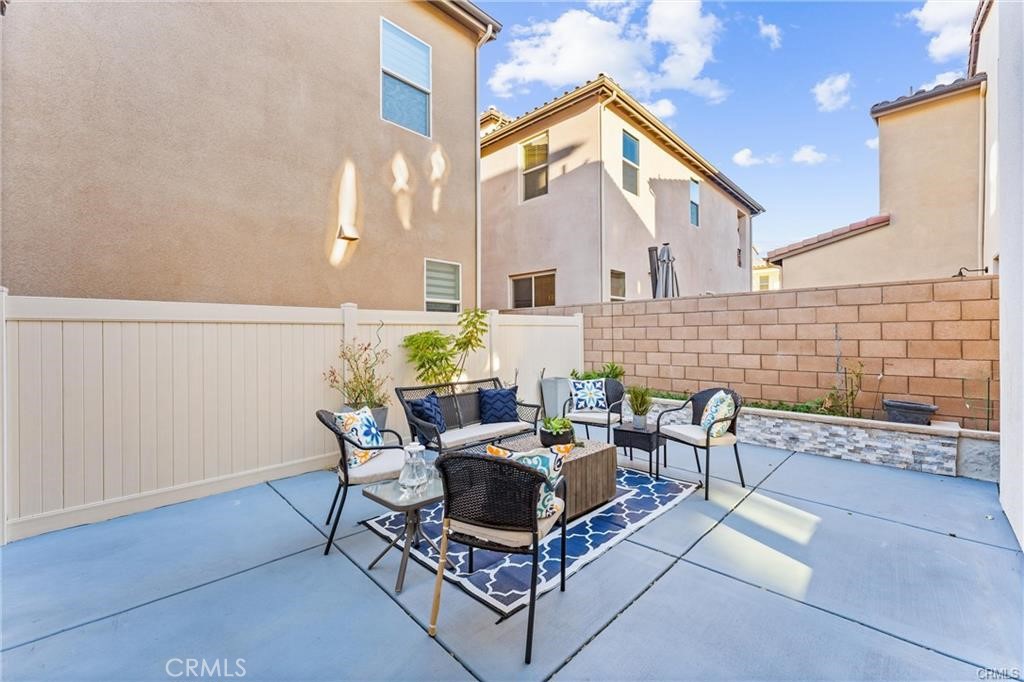 117 Denali Lake Forest, CA 92630 - Photo 25 of 40 a view of a patio with couches and a table and chairs