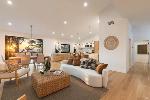 a living room with furniture a rug and a clock