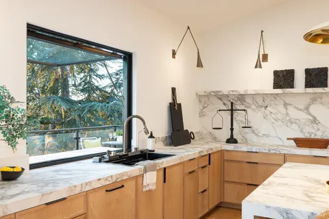 a bathroom with a granite countertop sink and a bathtub