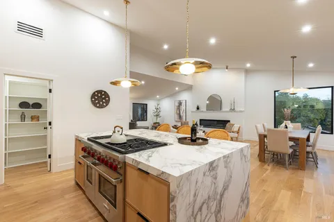 a kitchen that has a table and chairs in it