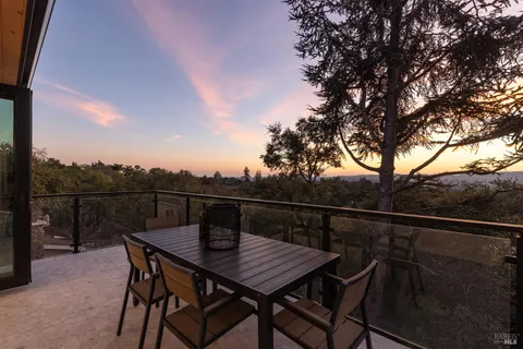 an aerial view of a house with a yard and lake view
