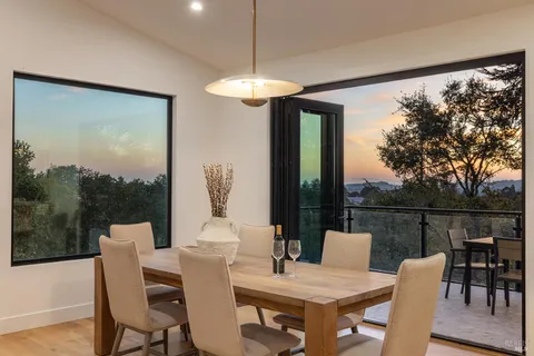 a view of a dining room with furniture window and outside view
