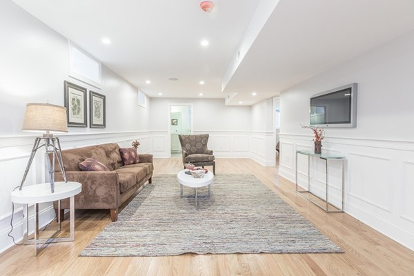 9 Bartlett Crescent, Unit 1 Brookline, MA 02446 - Photo 11 of 19 a living room with furniture and a flat screen tv