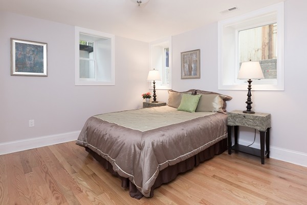 9 Bartlett Crescent, Unit 1 Brookline, MA 02446 - Photo 13 of 19 a bedroom with a bed and a lamp