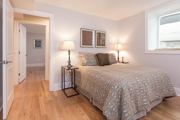 9 Bartlett Crescent, Unit 1 Brookline, MA 02446 - Photo 14 of 19 a bedroom with a bed and a window