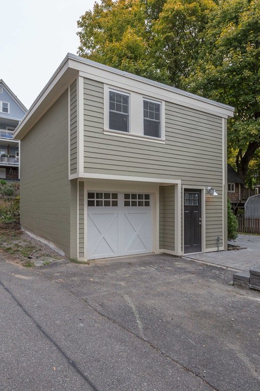 9 Bartlett Crescent, Unit 1 Brookline, MA 02446 - Photo 16 of 19 a front view of a house with a garage