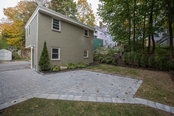 9 Bartlett Crescent, Unit 1 Brookline, MA 02446 - Photo 17 of 19 a front view of a house with garden