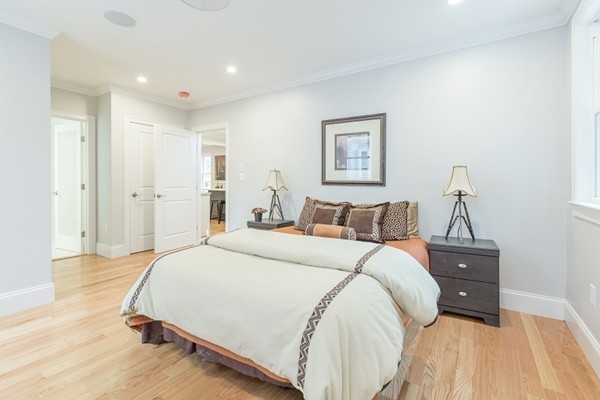 9 Bartlett Crescent, Unit 1 Brookline, MA 02446 - Photo 5 of 19 a bed room with a bed and a dresser