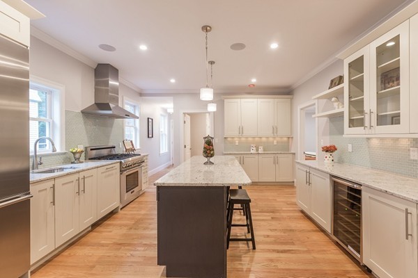 9 Bartlett Crescent, Unit 1 Brookline, MA 02446 - Photo 6 of 19 a large kitchen with stainless steel appliances kitchen island granite countertop a sink and cabinets