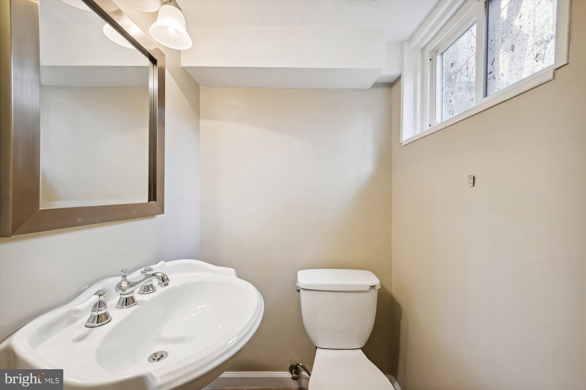 4545 Marble Hall Road Baltimore, MD 21239 - Photo 33 of 36 a bathroom with a sink and a toilet