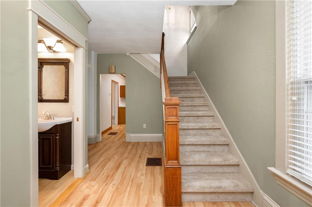 313 Oak Street Butler, PA 16001 - Photo 2 of 23 a view of a hallway with wooden floor and staircase
